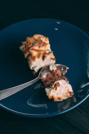 Curd cake in a plate lies on a wooden backgroundの写真素材