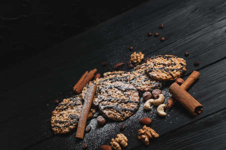 Homemade dessert biscuits on a white wooden background with cinnamon and nuts. Chocolate chip, oatmeal raisin, dough and nuts. Copy text menu food background.の写真素材