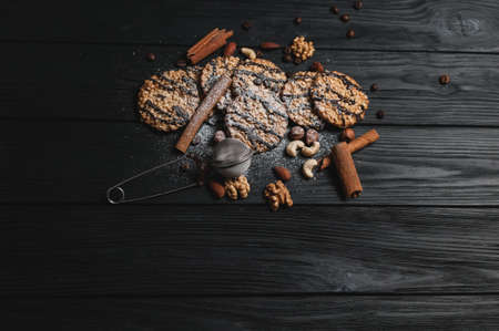 Homemade dessert biscuits on a white wooden background with cinnamon and nuts. Chocolate chip, oatmeal raisin, dough and nuts. Copy text menu food background.の写真素材