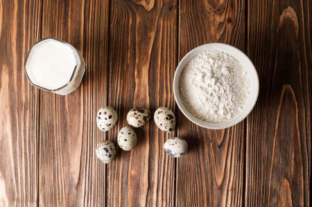 Baking ingredients for homemade pastry on dark rustic wooden background. culinary concept Copy space.の写真素材