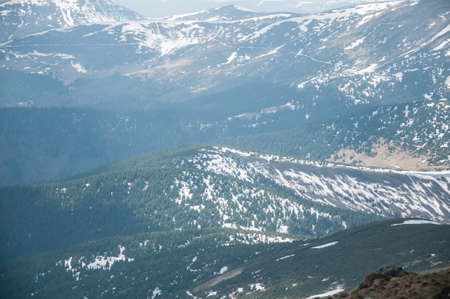 A beautiful panoramic view of the snow-capped mountains of the Carpathians from the top of Goverly...