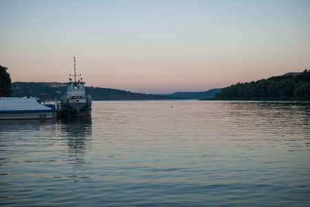 Old ships are in the bay at the dock at sunset on the fjords. Bakota, Ukraineの写真素材