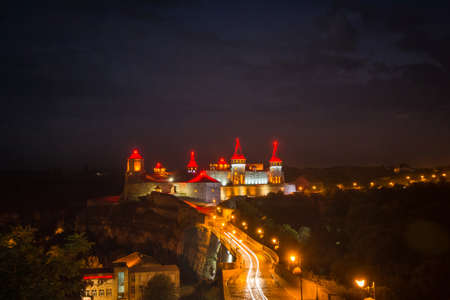 Old fortress at night with illumination in the ancient city of Kamenets-Podolsk, Ukraineの写真素材