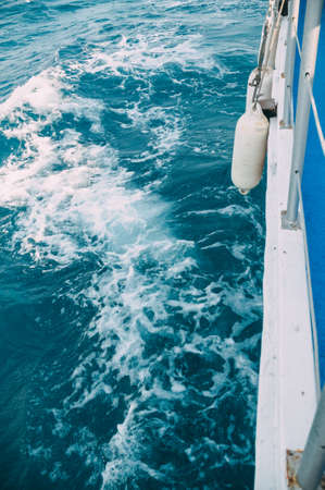 Dark turquoise waves of the Aegean Sea diverging from the yacht. Turkey, Bodrumの写真素材