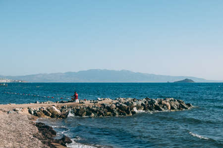 A fisherman catches fish in the seaの写真素材