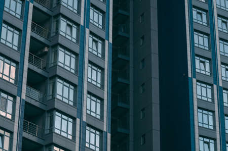 Bottom view of modern skyscrapers in business district against blue sky