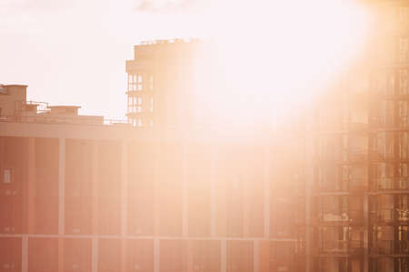 Bottom view of modern skyscrapers in business district against blue skyの写真素材
