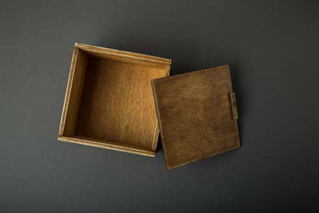 Wooden box, gift wrap, on a dark background.