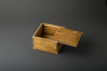 Wooden box, gift wrap, on a dark background.の写真素材