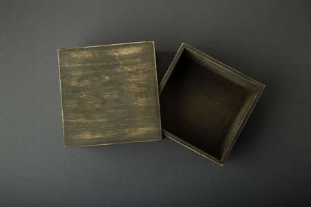 Wooden box, gift wrap, on a dark background.