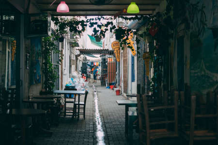 Turkey, Turgutreis, June 10, 2018: A small street near the local bazaar, where 2 local residents argue, a small resort town near Bodrum.のeditorial素材