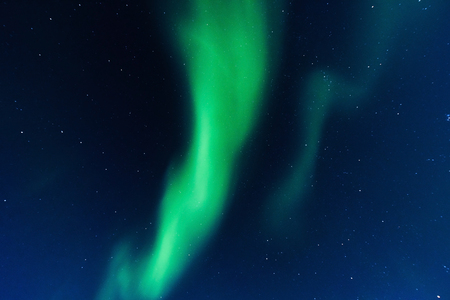 The polar Northern aurora borealis lights in Norway Svalbard in the mountainsの写真素材