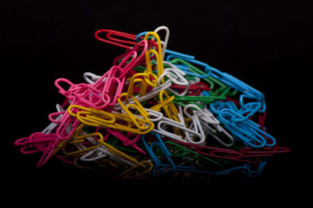 photo of colorfull paper clips on a black backgroundの写真素材