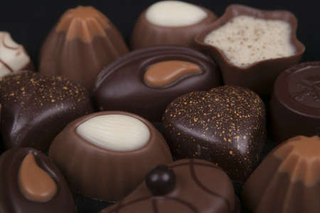 close - up photo of chocolates isolated on a black background