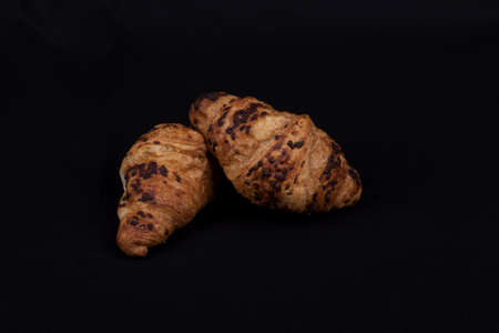 fresh chocolate croissant isolated on a black backgroundの写真素材