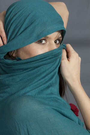 Woman with green  shawl on faceの写真素材