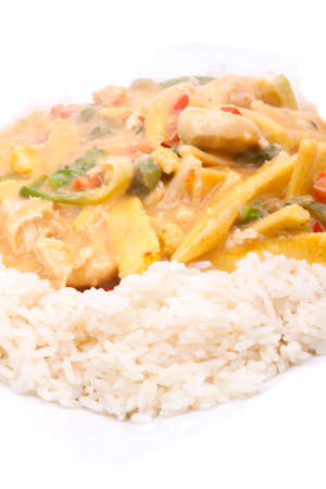 diced chicken in coconut curry sauce served with riceの写真素材