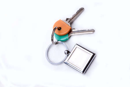 A bunch of keys with a key ring, isolated on a white background の写真素材