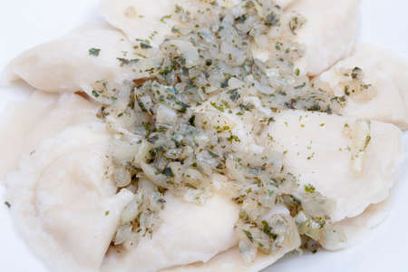 homemade traditonal polish pierogi topped with fried onionsの写真素材