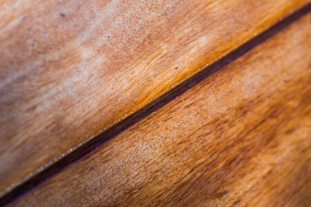 Closeup of exotic wooden desk background - shallow depth of fieldの写真素材