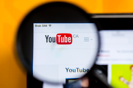 Poznan, Poland - April 15, 2015: YouTube CA website home page on Ipad display  - seen through magnifying glass (loupe) YouTube is the popular online video-sharing website, founded in February 14, 2005のeditorial素材
