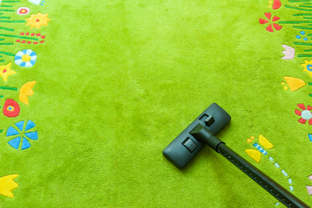 Vacuum cleaner cleans carpet, with copy space for text message, advertising - Spring Cleaning Conceptの写真素材