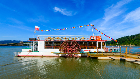 Niedzica, Poland - August 28, 2015: tourist boat - paddle steamer - on Czorsztynskie lake. Popular way - for many tourists - to get to ruins of Czorsztyn castle located on the other side of the lakeのeditorial素材