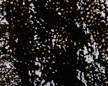 Colorful background - textured black wet plasticine - irregular pattern