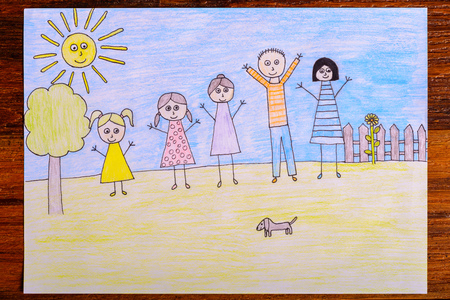 Happy family drawing - kids crayon drawing on wooden tableの写真素材