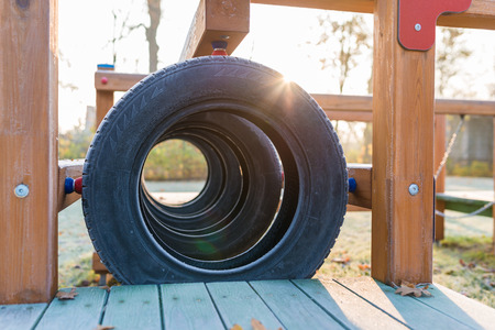 Empty wooden playground at sunrise in autumn scenery - frozen tiers detailの写真素材