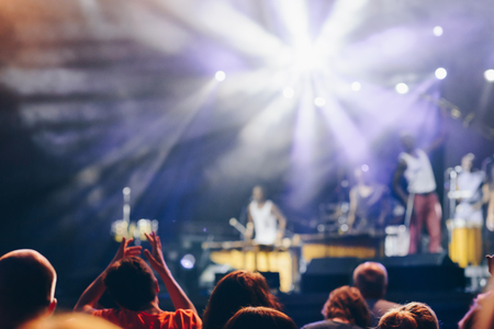 Blurred Crowd at concert of unrecognizable music group and blurred stage lightsの写真素材