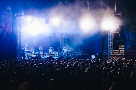 Blurred Crowd at concert and blurred stage lights - Unrecognizable GROUPS OF MUSICIANS ON STAGEの写真素材
