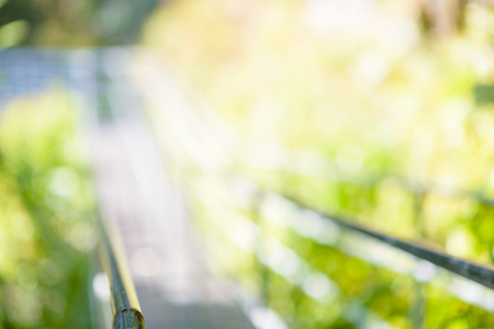 steel suspension footbridge in mountains - image with natural extremely shallow depth of field - ready for backgroundの写真素材