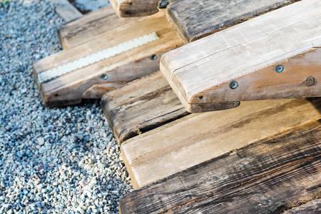 Wooden rafting boats on a pile on the river bank - stored in partsの写真素材