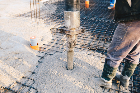 Concrete pouring during commercial concreting floors of buildings in construction site - concrete slabの写真素材