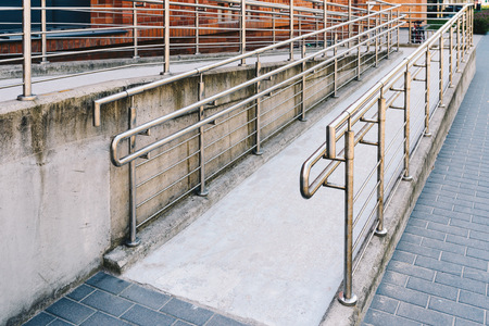 Concret ramp way with stainless steel handrail for support wheelchair disabled peopleの写真素材