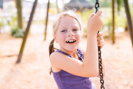 laughing girl on a swing - shallow depth of fieldの写真素材