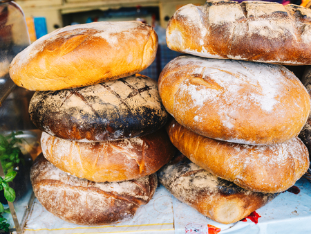 loaves of homemade bread baked in a traditional wood-fired ovenの写真素材