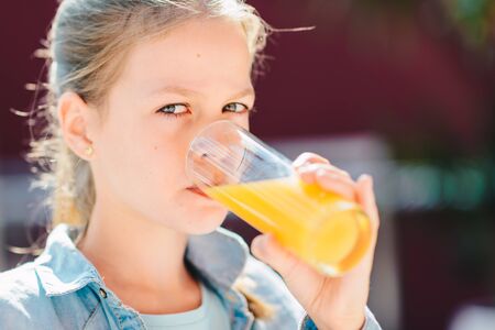 Teenage girl drinking fresh orange juice.  Healthy Lifestyle, Vegetarian Diet And Meal. Drink Juice. Health Care And Beauty Conceptの写真素材