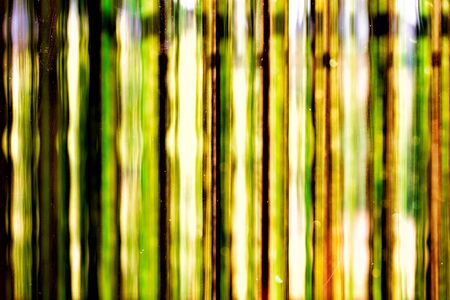 Abstract background - greenish strings behind the glass - water colors in the area of intentional...