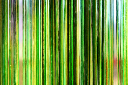 Abstract background - greenish strings behind the glass - water colors in the area of intentional defocus macroの写真素材