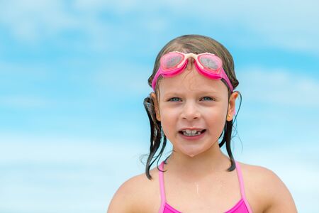 Little Girl in swimming goggles - after swimming in the seaの写真素材