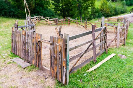 Empty simple wooden mountain sheep farm on a hillsideの写真素材