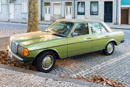 Porto, Portugal - October 7, 2018: Green Mercedes Benz W123 glossy and shiny old classic retro car...