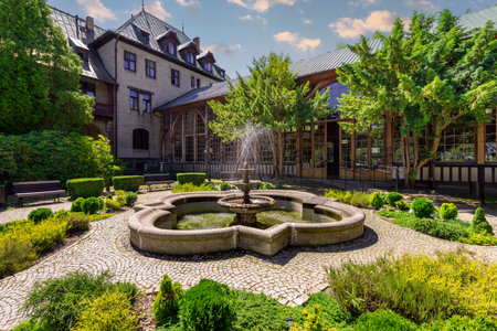 Swieradow-Zdroj, Poland - June 24, 2019; Spa House - a stone fountain in front of the side entrance to the longest Walking Hall in Lower Silesia (80 meters)のeditorial素材