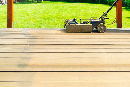 Machine cleaning of a wooden terrace - dry method - grinding the boards with sanding machine, preparing for oiling the terraceの写真素材