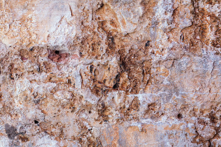 Textured Surface of Natural Stone - Detailed Close-Up for Backgrounds. Detailed view of the patterns intricately found in natural stone which can be used for backgrounds in design projectsの写真素材
