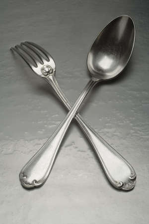 old silver fork and spoon on the water coated backgroud