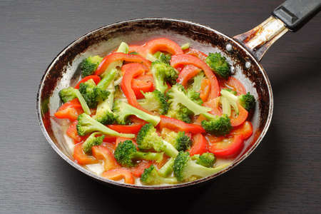 cooking pepper and broccoli with oilの写真素材