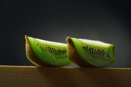 still life with two pieces of kiwi fruitの写真素材